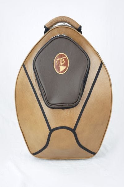 Cover in leather light brown and dark brown with embroidery logo