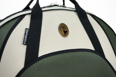 Cover in nylon moss green and beige with metal logo